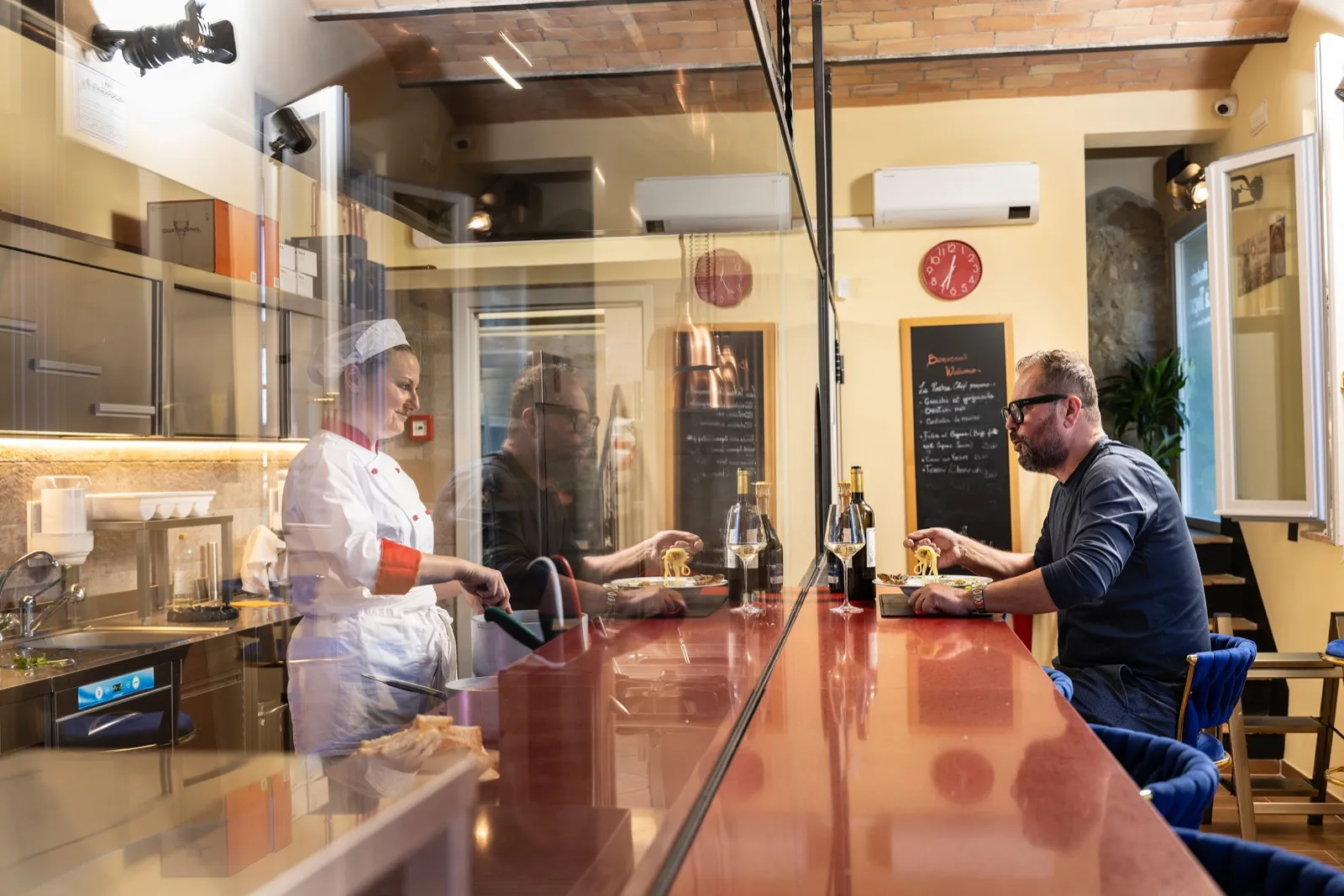 La cucina a vista e l'area bar della Hosteria La Togata